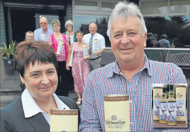  ??  ?? Launching the Red Lichtie whisky are Freda Wells (manager of the Meadowbank Inn) and Harry Simpson (chairman of the Red Lichtie Group). design.Inset, the whisky’s label