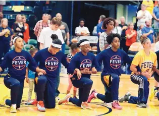  ?? DARRON CUMMINGS/ASSOCIATED PRESS ?? Members of the Indian Fever kneel during the playing of the national anthem before the start of Wednesday’s playoff game against the Phoenix Mercury.