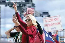  ?? LYNNE SLADKY / AP ?? Supporters of President Donald Trump wave as the motorcade passes by on the road to Mar-a-Lago, Trump’s Palm Beach estate, on Wednesday in West Palm Beach, Fla.