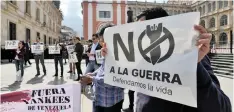  ?? | Reuters ?? A GROUP of demonstrat­ors takes part in a protest against the Venezuelan opposition leader Juan Guaido, as a meeting of the Lima Group takes place in Bogota, Colombia, yesterday. The placard reads ‘No to the war, we defend life’.