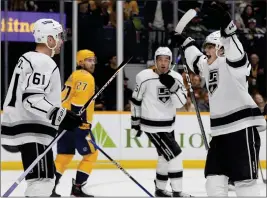  ?? GEORGE WALKER IV — THE ASSOCIATED PRESS ?? The Kings' Alex Turcotte, right, celebrates after a goal by Trevor Lewis (61) in the third period at Nashville. Turcotte scored his first NHL goal in the second period.