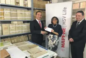  ??  ?? Notarial Archives MMSV Presentati­on: Michael Galea presents the donation to Dr. Joan Abela in the presence of Chief Notary to Government Dr. Keith German (from left to right).