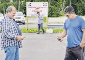  ??  ?? Lyft drivers mike ohlidal, left, of Gloversvil­le and doug Pollicino, right, of Summit check for their next customers.