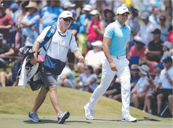  ?? Picture: AP ?? Jason Day in tournament play with his former caddy Col Swatton earlier this year. The former world No.1 cut Swatton as his bagman this week.