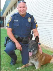  ??  ?? Kai, the Cedartown Police Department’s trusted K-9, sits with his handler Sgt. John Zuker. Kai will remain with Zuker through his golden years but will have a separate kennel from his replacemen­t Baro.