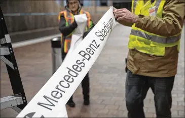  ?? ALYSSA POINTER/ALYSSA.POINTER@AJC.COM ?? Employees of Advantage Graphics &amp; Signs rolled out the new signage that will direct attendees to Mercedes-Benz Stadium at the MARTA Dome/GWCC/Philips Arena/CNN Center Transit.