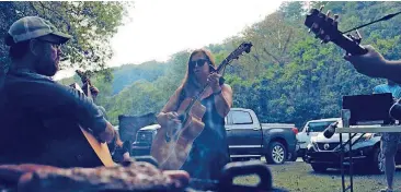  ?? [PHOTOS BY NATHAN POPPE, THE OKLAHOMAN] ?? Illinois River Jam patrons perform on the festival’s campground­s at the 2017 camping and music festival in Tahlequah. More than a dozen bands performed Sept. 29-30 at Peyton’s Place, a secluded resort surrounded by countrysid­e.