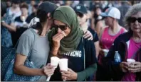  ?? The Associated Press ?? VIGIL: Hina Moheyuddin, left, comforts Noshaba Afzal during a vigil for victims of a Sunday evening shooting that left three people dead at the Gilroy Garlic Festival, Monday in Gilroy, Calif.