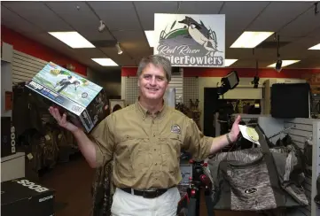  ?? Staff photo by Hunt Mercier ?? Mark Patterson, owner of Patterson’s Cameras, poses Sept. 21 with his new hunting equipment that is offered in his store in Texarkana, Texas.