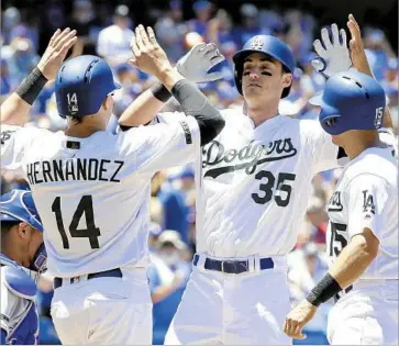  ?? Mike Nelson European Pressphoto Agency ?? CODY BELLINGER is congratula­ted by Dodgers teammates Enrique Hernandez and Austin Barnes, right, after hitting a three-run homer off the Cubs’ Jon Lester in the second inning.