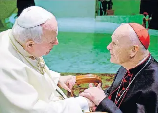  ?? ASSOCIATED PRESS FILE PHOTO] ?? In this Feb. 23, 2001, photo, U.S. Cardinal Theodore Edgar McCarrick, archbishop of Washington, D.C., shakes hands with Pope John Paul II during the General Audience with the newly appointed cardinals in the Paul VI hall at the Vatican. McCarrick was one of the three Americans on a record list of 44 new cardinals who were elevated in a ceremony at the Vatican on Feb. 21, 2001. [MASSIMO SAMBUCETTI/