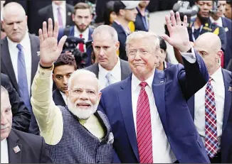  ?? (AP) ?? In this Sept 22, 2019, file photo, India Prime Minister Narendra Modi and President Donald Trump walk the perimeter of the arena floor to greet attendants after Modi’s speech during the ‘Howdi Modi’ event at NRG Stadium in Houston. President Donald Trump is ready for a king’s welcome as he head to India on Sunday for a jam packed two-day tour. The visit will feature a rally at one of the world’s largest stadiums, a crowd of millions cheering him on and a lovefest with a like-minded leader during an election year.