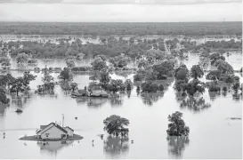  ?? Michael Ciaglo / Houston Chronicle ?? A home sits under water as the Brazos River floods on June 4. Brazoria County is one of 12 eligible for federal assistance to help recover from the early June floods after President Barack Obama approved Gov. Greg Abbott’s request.