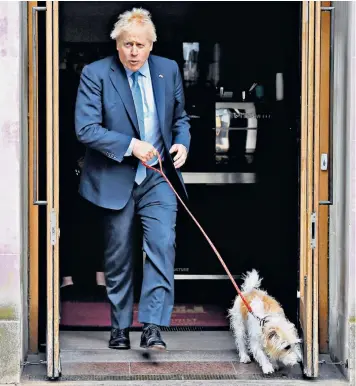  ?? ?? Boris Johnson cast his vote for the local elections with Dilyn the dog in Westminste­r yesterday