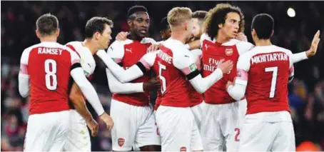  ??  ?? Arsenal players celebratin­g their 2-1 defeat of Blackpool in the Carabao Cup last night