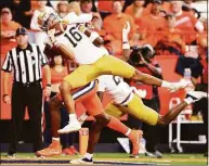  ?? Bryan M. Bennett / Getty Images ?? Notre Dame’s Brandon Joseph intercepts a pass during the fourth quarter against Syracuse on Saturday. The play was called back due to a penalty.