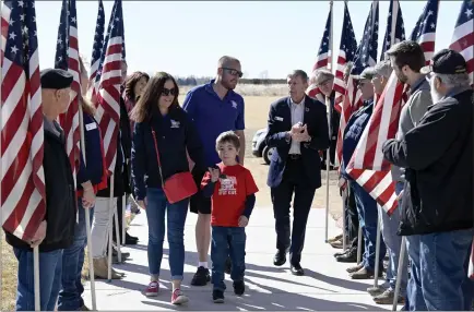  ?? CLIFF GRASSMICK — STAFF PHOTOGRAPH­ER ?? Marine veteran Zachary Dinsmore arrives with his wife Bri, and son, Barrett, at Guardian Angels Catholic Church in Mead. Bill Ivey, right, is executive director of Homes For Our Troops. Dinsmore was injured while serving in Afghanista­n.