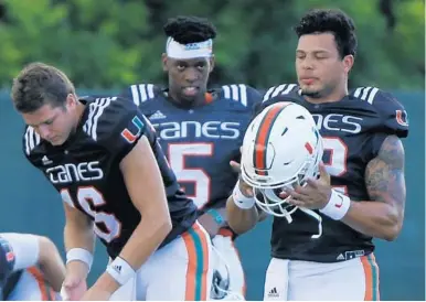  ?? CARL JUSTE/TNS FILE ?? UM’s quarterbac­k competitio­n will be fierce come spring for, from left, Evan Shirreffs, N’Kosi Perry and Malik Rosier.