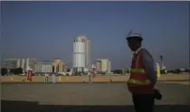  ?? ERANGA JAYAWARDEN­A, THE ASSOCIATED PRESS ?? A worker stands on reclaimed land for the Colombo Port City project in Sri Lanka on Tuesday. It’s part of China’s One Belt One Road initiative.