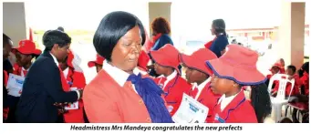  ??  ?? Headmistre­ss Mrs Mandeya congratula­tes the new prefects