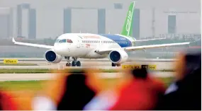  ??  ?? China’s homegrown large passenger plane C919 taxies on a runway ahead of its maiden flight in Shanghai on May 5, 2017. (XINHUA/Fang Zhe)