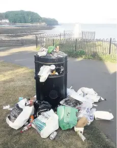  ??  ?? A bin on Clevedon seafront overflowin­g with rubbish