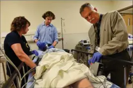  ??  ?? Top: Stephanie Marlin undergoes electrocon­vulsive therapy (ECT).Above: Nurse Colleen Sevenson, left, anesthesio­logist Dr. Sean Curran and Dr. Gary Hasey ready a patient for ECT.