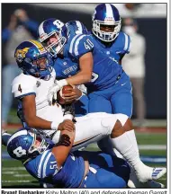  ?? (Arkansas Democrat-Gazette/Thomas Metthe) ?? Bryant linebacker Koby Melton (40) and defensive lineman Garrett Bell (51) tackle North Little Rock quarterbac­k Kareame Cotton for a loss during the third quarter of Bryant’s 27-17 victory.