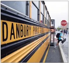  ?? H John Voorhees III / Hearst Connecticu­t Media ?? Students get off the buses at Danbury High School on Aug. 30, the first day of the new school year.