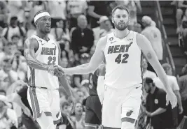  ?? AL DIAZ adiaz@miamiheral­d.com ?? Kevin Love (42) celebrates with Jimmy Butler in Saturday’s win. ‘We knew we were up against the odds being the eighth seed,’ he said. ‘[But] we feel like we can beat anyone.’