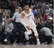  ?? MARCIO JOSE SANCHEZ — THE ASSOCIATED PRESS ?? Clippers guard Russell Westbrook is energized after scoring on a breakaway dunk in the second half against the Nets.