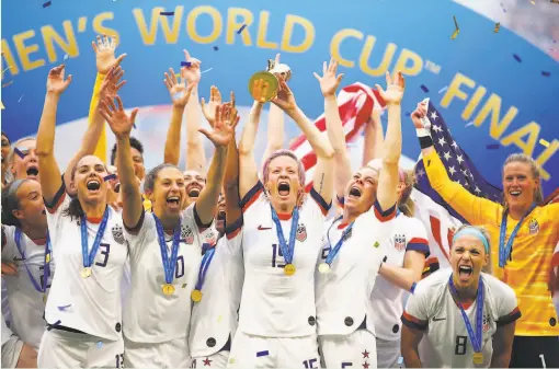  ?? Richard Heathcote / Getty Images ?? Megan Rapinoe lifts the World Cup trophy after the United States scored a 20 victory over the Netherland­s in Lyon, France, for its fourth title.