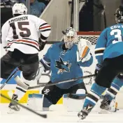  ?? JOSIE LEPE/STAFF ?? Sharks goaltender Martin Jones makes a save against the Blackhawks. He has a capable backup in Aaron Dell, which gives the teama leg up on much of the competitio­n.