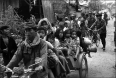  ?? AP PHOTO ?? Cambodian women and children fill the back of a motorcycle taxi carrying them to safer parts of Phnom Penh as Khmer Rouge insurgents continue their artillery shellings of the capital, Jan. 28, 1974.