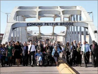  ?? The New York Times/DOUG MILLS ?? President Barack Obama (center, left) leads a march Saturday across the Edmund Pettus Bridge in Selma, Ala., on the 50th anniversar­y of “Bloody Sunday.” In blue shirt at right is former President George W. Bush.