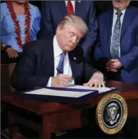  ?? The Associated Press ?? BILL SIGNING: President Donald Trump signs the "Department of Veterans Affairs Accountabi­lity and Whistleblo­wer Protection Act of 2017" in the East Room of the White House on Friday in Washington.