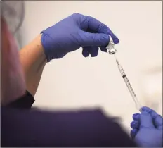  ?? Tyler Sizemore / Hearst Connecticu­t Media ?? Nurse Carly Plymel preps a dose of the Pfizer COVID-19 vaccine at the Stamford Health Vaccinatio­n Super Site April 6.