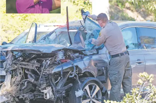  ?? RINGO H.W. CHIU/ASSOCIATED PRESS ?? A law enforcemen­t officer looks over a damaged vehicle following a rollover involving golfer Tiger Woods on Tuesday in the Rancho Palos Verdes suburb of Los Angeles. Woods was hospitaliz­ed and underwent surgery.