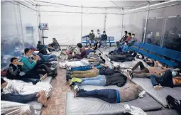  ?? DARIO LOPEZ-MILLS/AP ?? Children lie inside a “pod” Tuesday at the Department of Homeland Security holding facility in Donna, Texas. Journalist­s were allowed in for the first time.
