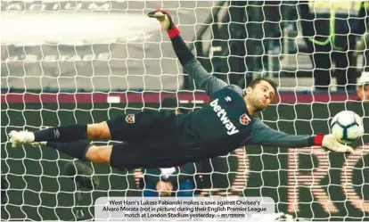  ??  ?? West Ham’s Lukasz Fabianski makes a save against Chelsea’s Alvaro Morata (not in picture) during their English Premier League match at London Stadium yesterday. –