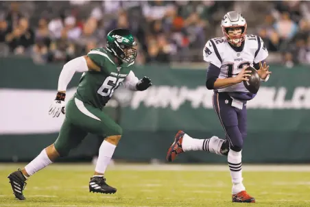  ?? Adam Hunger / Associated Press 2019 ?? Jordan Willis, then with the Jets, chases the Patriots’ Tom Brady last season. The 49ers acquired Willis in a trade Wednesday.
