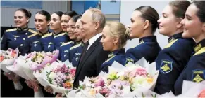  ?? ?? Hello Mr President: Putin posing with female graduates of the higher Military aviation School of Pilots named after hero of the Soviet union ak Serov in Krasnodar. — Reuters