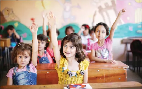  ??  ?? Syrian pupils attend a school in the opposition-held Eastern Ghouta town of Douma. Syria’s six-year conflict has ravaged its infrastruc­ture and caused losses to its economy of $226 billion, according to estimates published by the World Bank. (AFP)