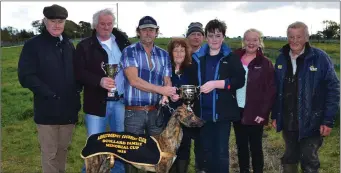  ??  ?? ICC Secretary DJ Histon pictured with the O’Sullivan family after they presented the Scollard Family Memorial cup to Jeremiah Dennehy after his dog, Cutting Edge, won at Abbeydorne­y last Sunday.