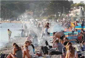  ??  ?? Packed: Visitors soak up the sun and enjoy barbecues on Sandbanks beach