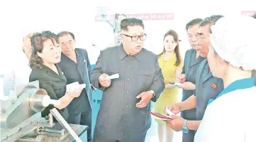  ?? — AFP photo ?? Kim Jong Un and his wife Ri Sol Ju visiting a cosmetics factory in Sinuiju.