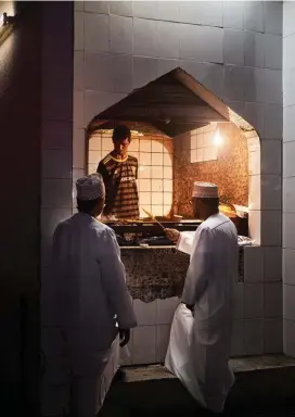  ??  ?? PREVIOUS PAGES The town of Birkat Al Mawz at the foot of the Jabal Akhdar range, Oman. Left: a mishkak vendor near the Seeb souk in Muscat. Far left: prayer time at Muscat’s Grand Mosque.