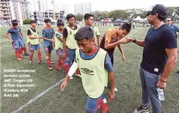  ?? FOTO: SADDAM YUSOFF ?? KHAIRY bersalaman bersama pemain AMD Cougars U14 di Piala Supermokh di padang MSN Bukit Jalil.