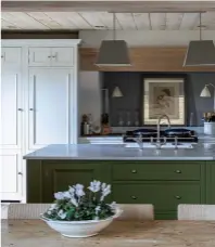  ??  ?? COLOUR BLOCK
Emma Sims-hilditch blends olive green with a classic white and ceilings in warm wood planks, creating a dramatic contrast. Chichester kitchen in Olive, Neptune. Countertop in Carrara marble, Anything Stone. Lighting,
similar by Original BTC