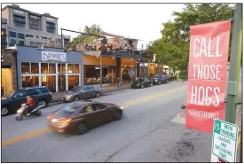  ?? NWA Democrat-Gazette/ANDY SHUPE ?? Thursday as a small crowd of people gathers in bars on Dickson Street.